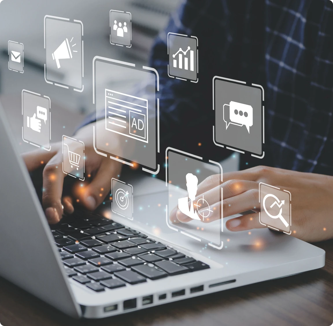 Person using laptop with digital marketing icons