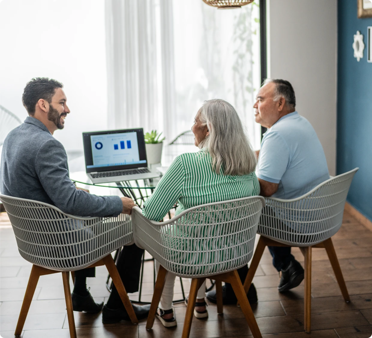 Financial consultation with charts on laptop.