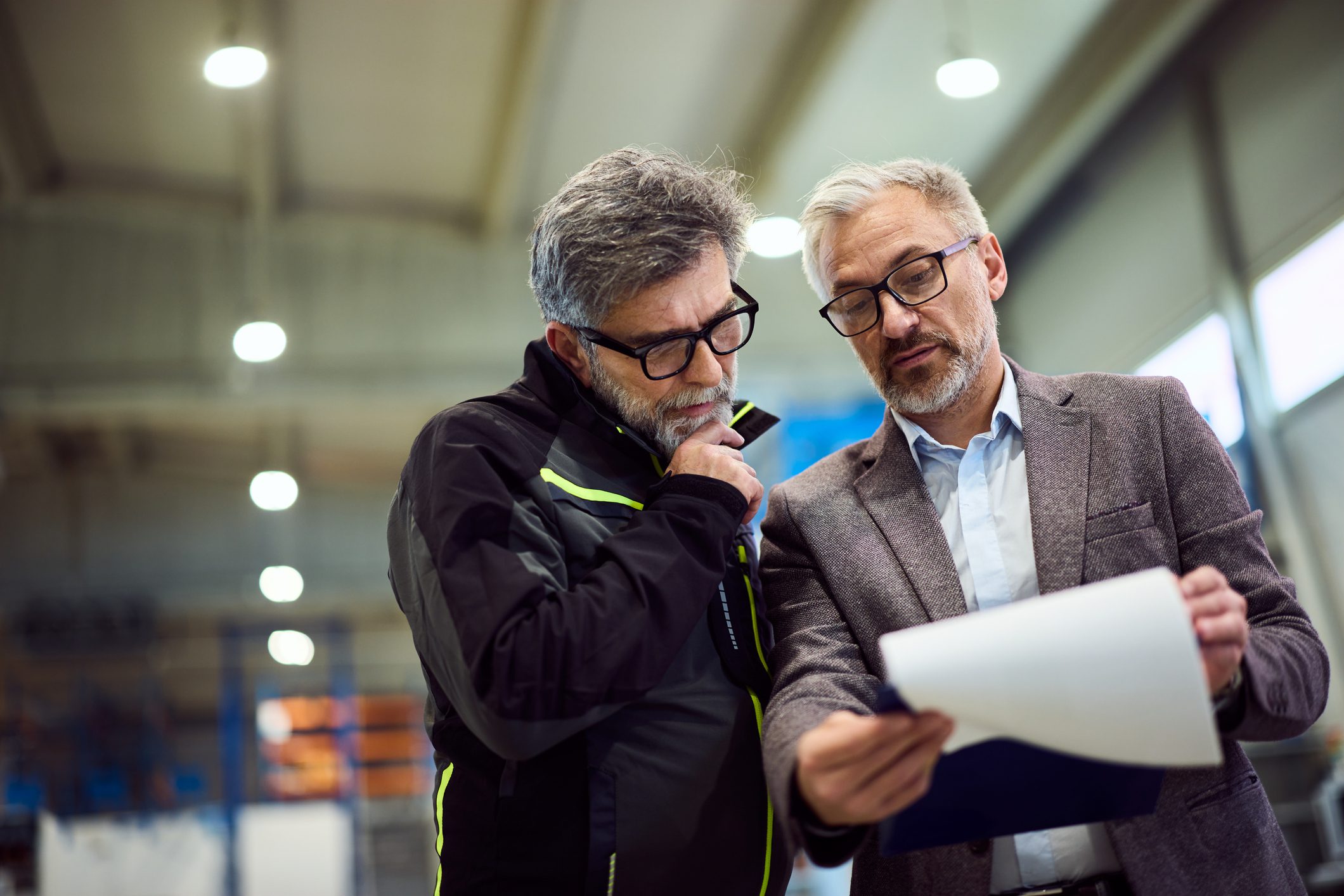 Two men reviewing a document together.